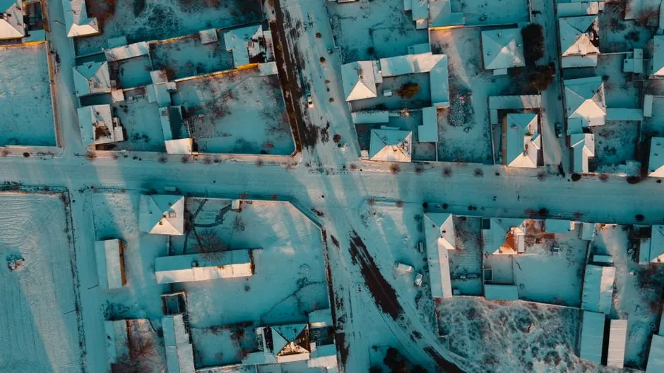 Aerial drone shot capturing a snow-covered residential neighborhood in Sarayönü, Konya, Turkey.