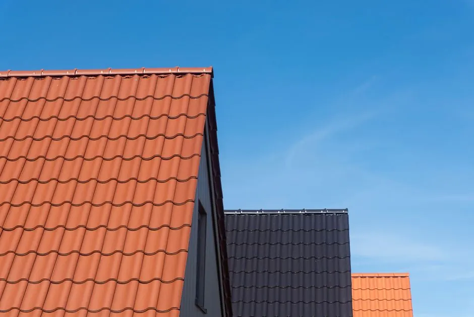 Vibrant rooftops contrasting with clear blue sky, showcasing architecture.